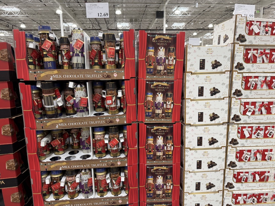 Character tins filled with chocolate truffles in festive packaging.