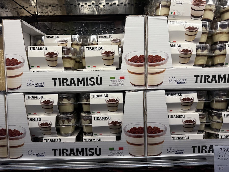 Set of six cups filled with creamy Italian tiramisu topped with cocoa powder.
