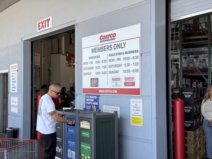 Costco building front displaying store hours for Gold Star and Executive Members.