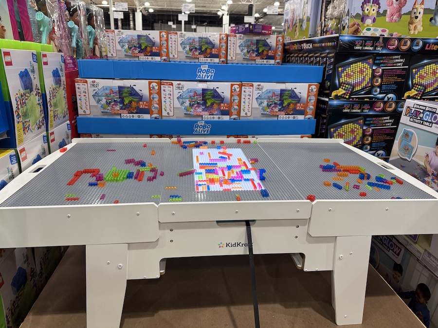 KidKraft Building Bricks Play N Glow Activity Table displayed on the floor.