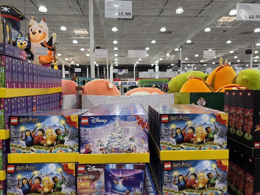 LEGO 2025 Advent Calendars arranged in colorful rows on a Costco display rack.