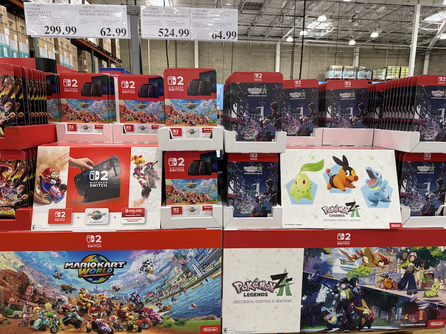 Nintendo Switch 2 + Mario Kart World Bundle stacked neatly on Costco shelves in bright red packaging.