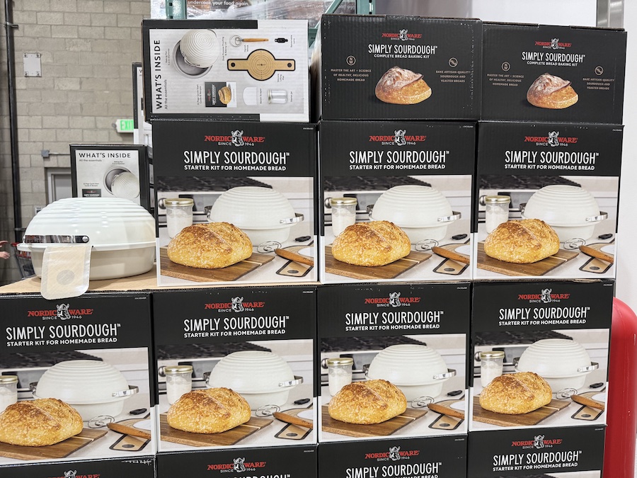 Sourdough kit with mixing bowl, starter packet, and instructions.
