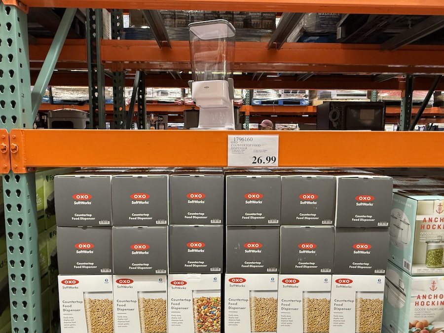 Costco display of OXO SoftWorks countertop food dispensers in retail packaging.