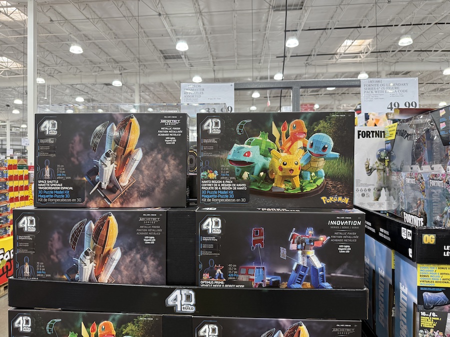 Spinmaster 4D Puzzles Assorted boxes neatly stacked on Costco store shelves in the toy aisle.