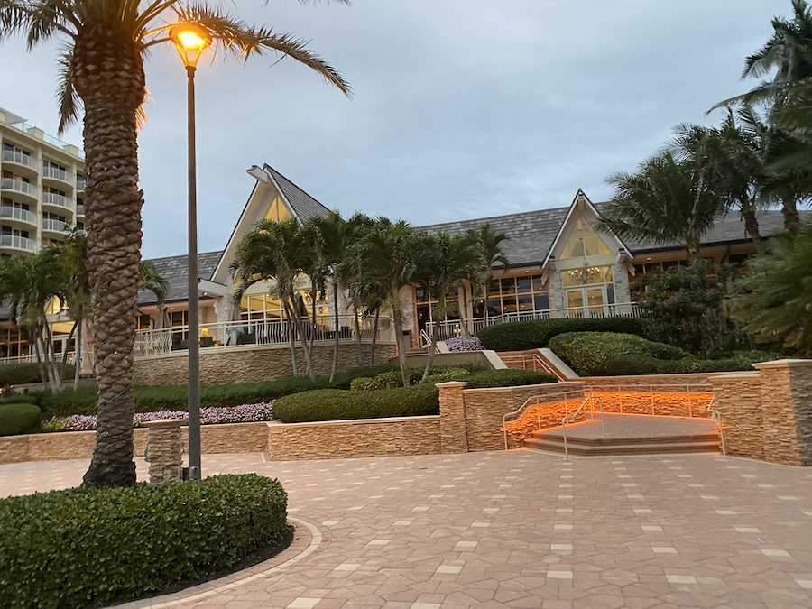 An exterior view of the low-rise resort building at dusk. 