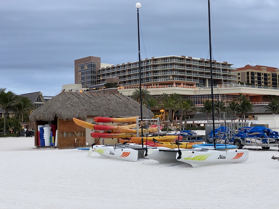 Catamarans and kayaks on the shore, waiting for tourists.