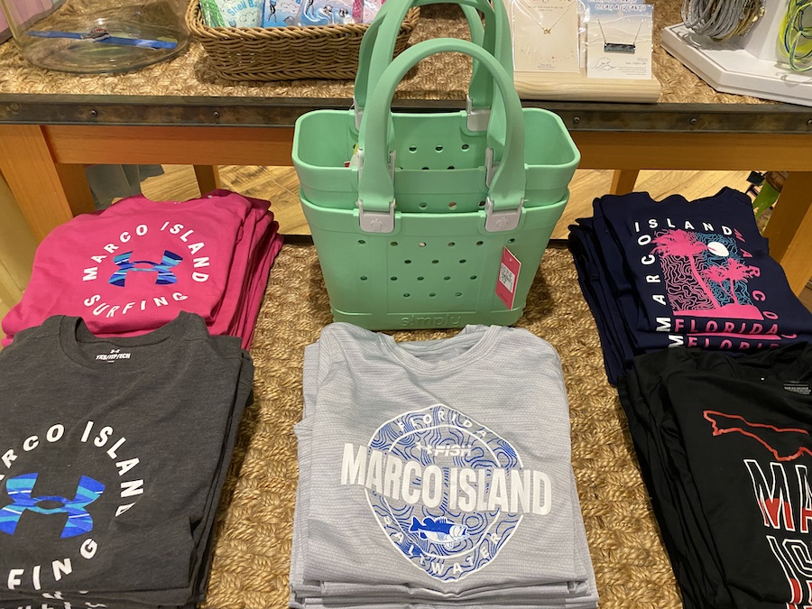 Bright tie-dye T-shirts printed with “Marco Island” in tropical fonts.