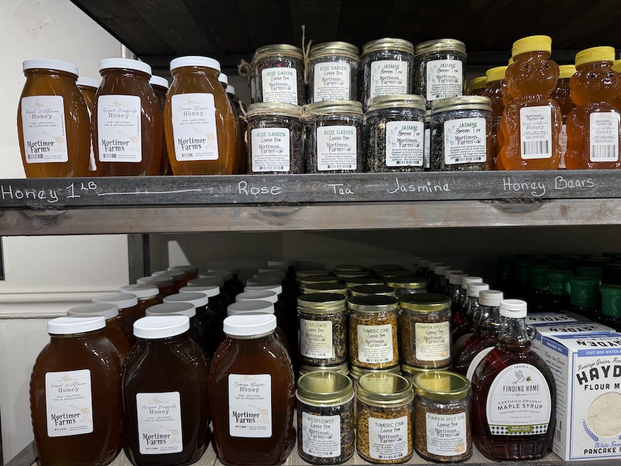 Jars of golden honey and bundles of herbal teas in the local goods section.