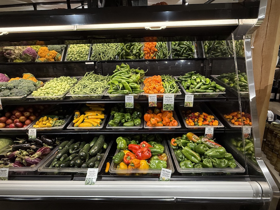 Fresh organic bright vegetables on shelves.