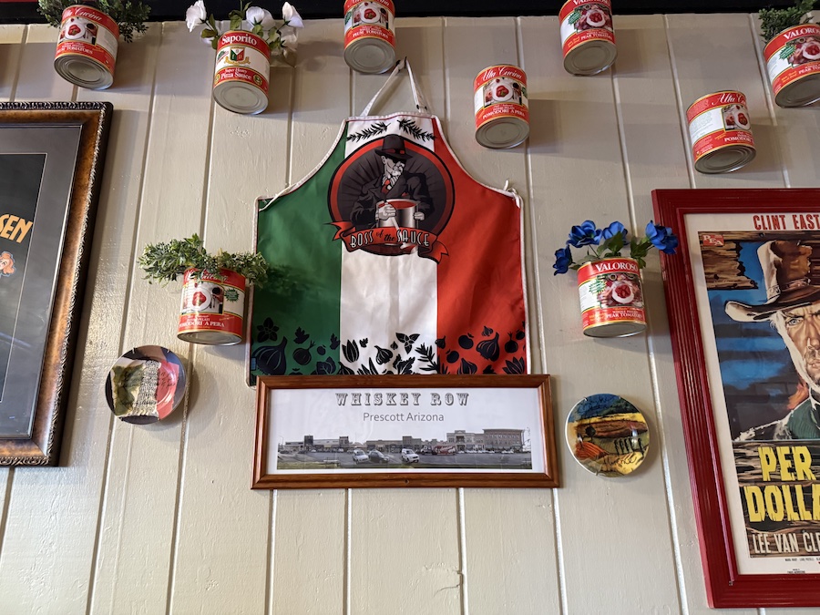 Wide view of the dining area with colorful wall décor, Italian phrases, and creative graffiti-inspired illustrations.