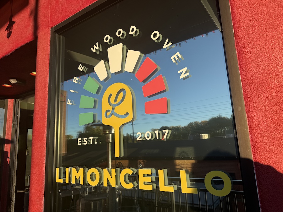 Elegant Italian restaurant serving traditional Neapolitan pizzas baked in a brick oven, with a warm, inviting interior.