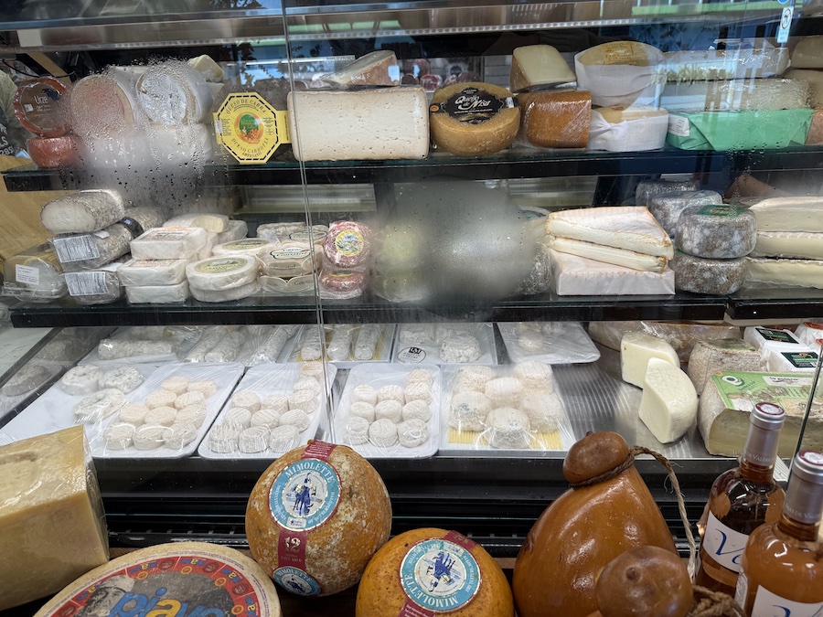 Glass case filled with rare and aged cheeses.