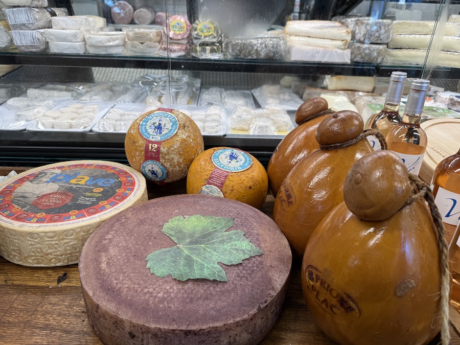 Interior view of the store with rustic décor and cheese wheels.