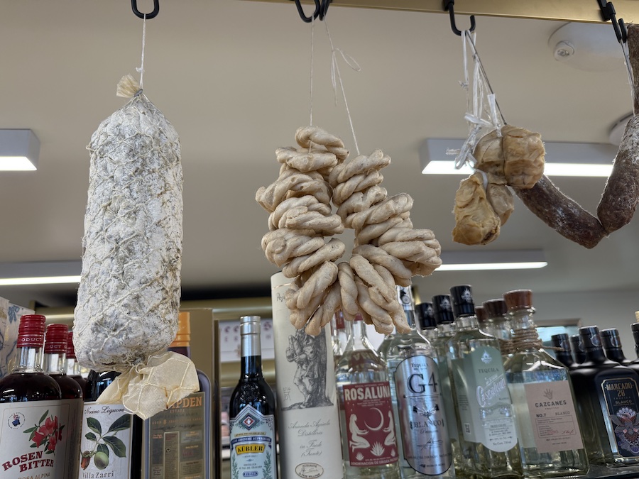 Meat products are hung above the counter.