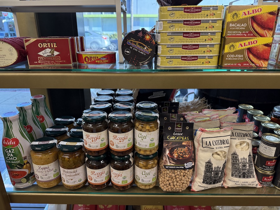 Gourmet tuna tins displayed with charcuterie and cheese pairing suggestions.