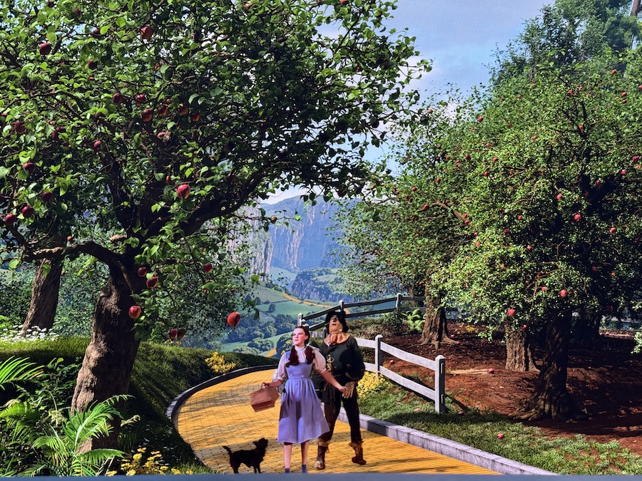 Dorothy and Toto walking the Yellow Brick Road on the Sphere’s panoramic stage.
