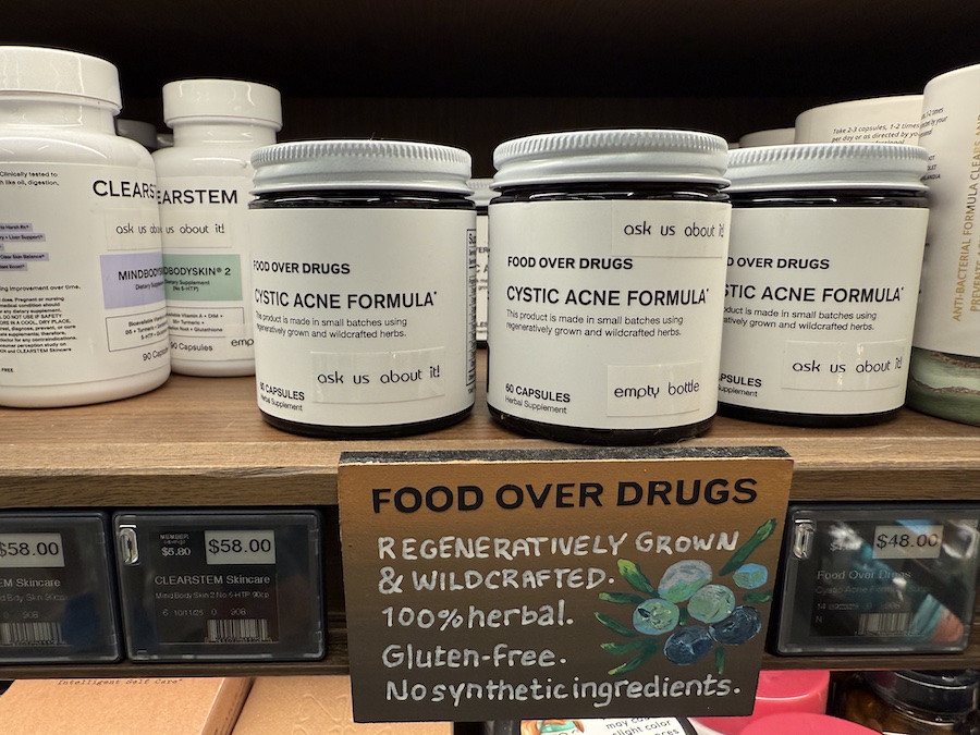Natural acne remedies from Food Over Drugs displayed in minimalistic packaging on the Erewhon skincare wellness shelf.