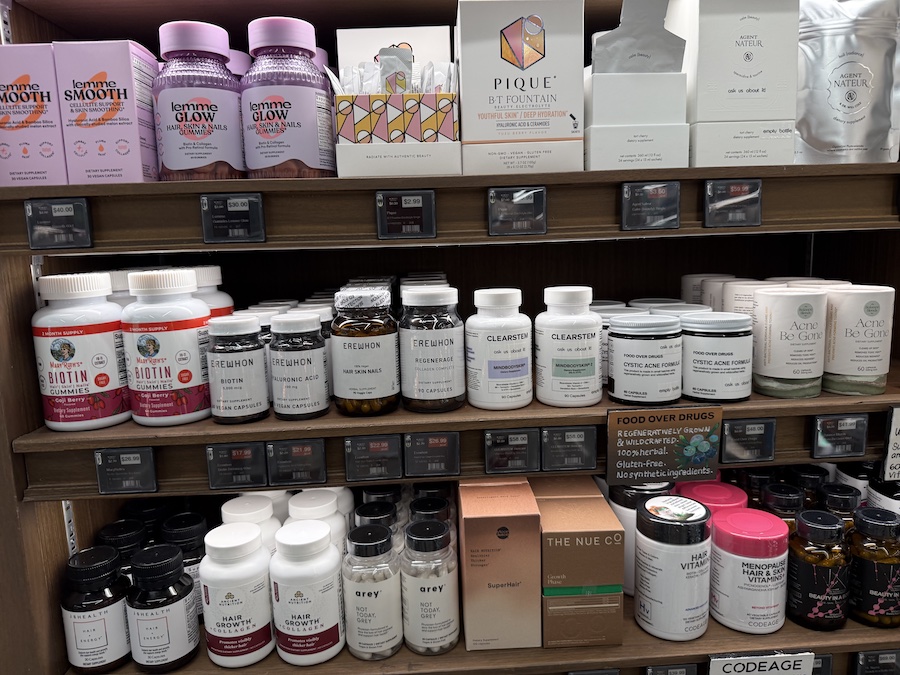 Display of beauty-focused supplements from Lemme Glow, Erewhon, and Clearstem promoting radiant skin and hair.
