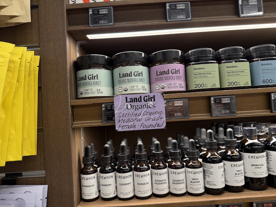 Elegant jars of Land Girl Organic Manuka Honey showcased with other natural immune-boosting products.