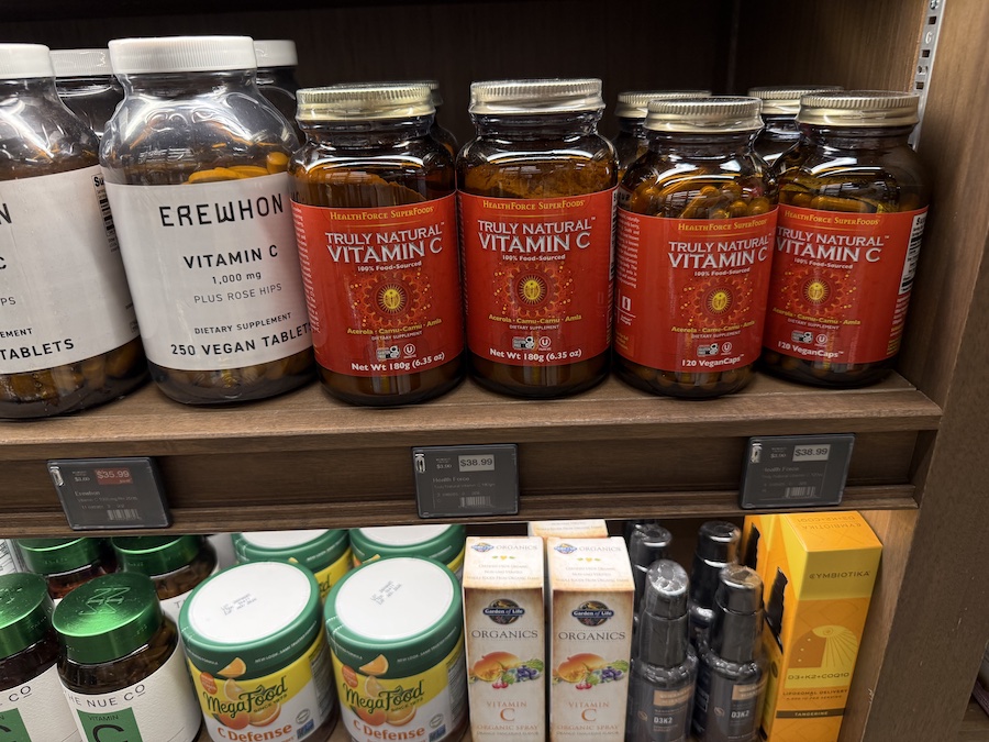 Selection of Vitamin C products from Erewhon, HealthForce SuperFoods, Garden of Life, MegaFood, and The Nue Co displayed in the supplement section.