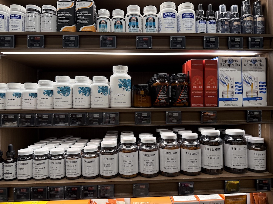 Shelves at Erewhon Manhattan Beach stocked with premium supplements from Pure Encapsulations, LifeSeasons Essentials, and Source Naturals.