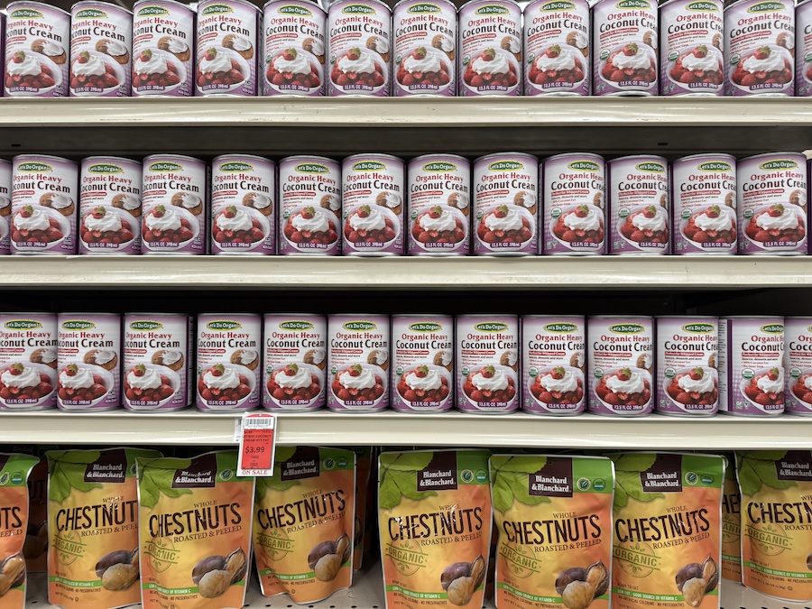 Cans of Let’s Do Organic coconut cream displayed in the baking ingredients section.