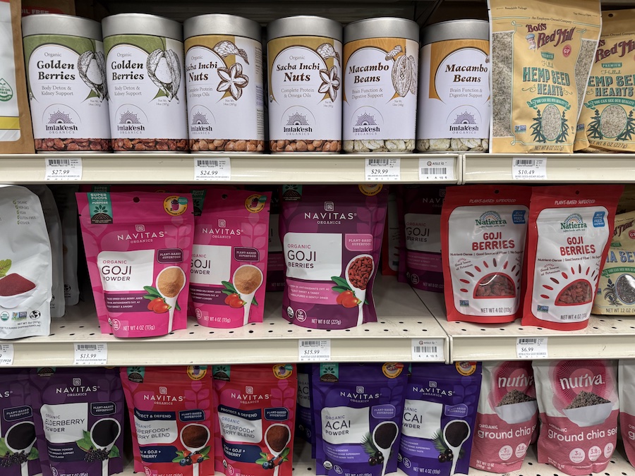 Colorful superfood mixes and dried berries from organic brands displayed in eco-friendly packaging.