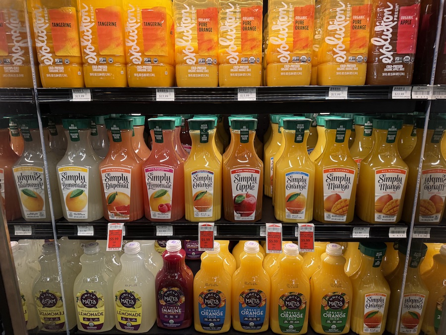 Fresh and cold-pressed juices from Evolution, Uncle Matt’s, and Simply arranged in a refrigerated case.