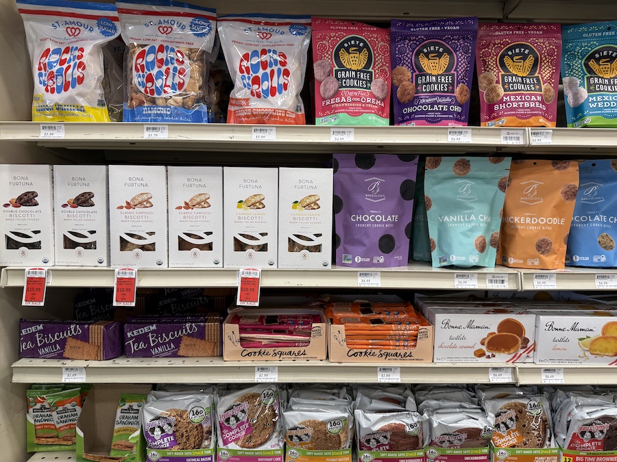 An assortment of gourmet and healthy cookies from popular brands neatly displayed on Mother’s California Market shelves, perfect for every sweet craving.