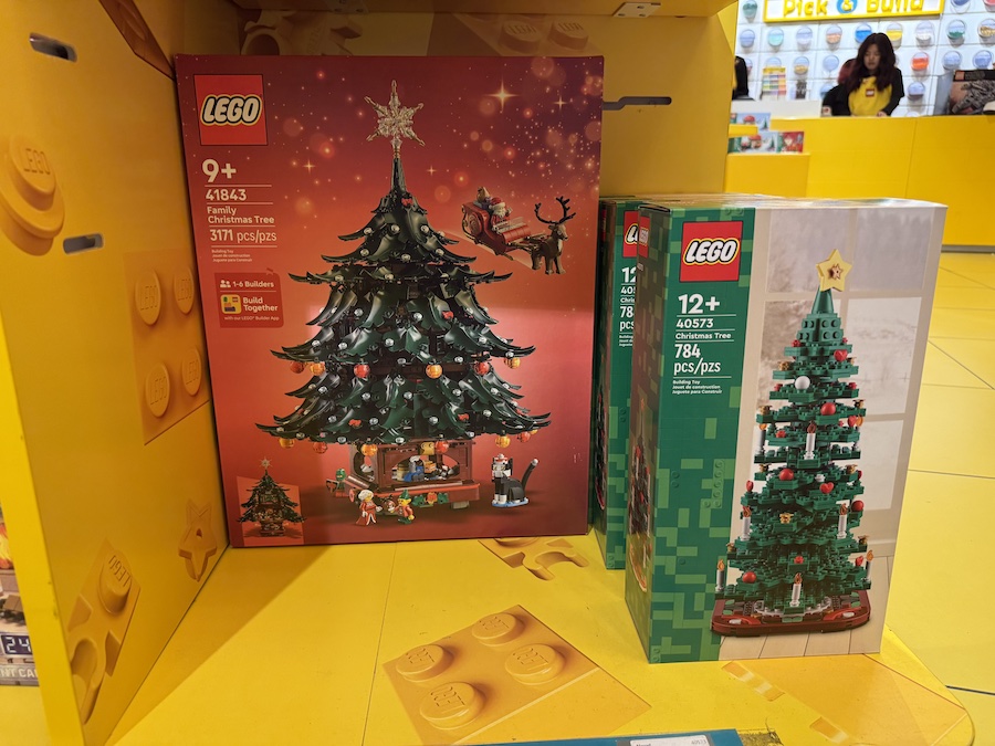 Display of LEGO Christmas tree sets in bright holiday colors