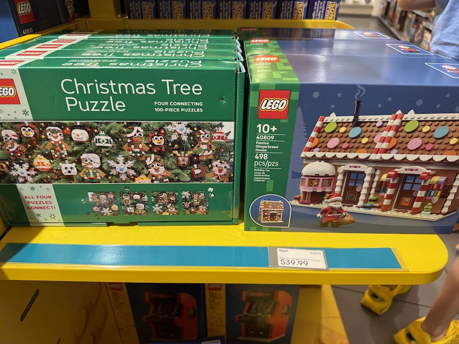 The LEGO Festive Gingerbread House set featuring colorful candy decorations, a gingerbread couple, and a cozy holiday theme.