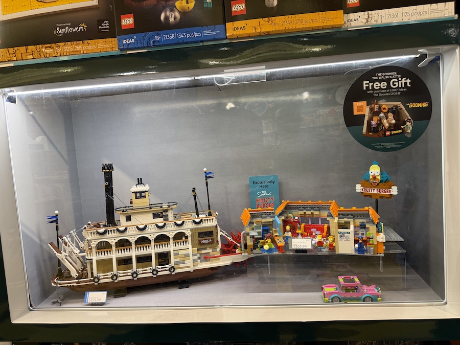 The LEGO Krusty Burger set displayed, showing the iconic Simpsons restaurant complete with minifigures and familiar scene details.