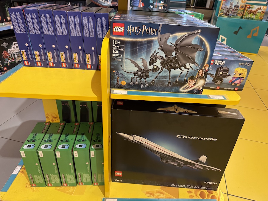 The LEGO Thestral Family set displayed with magical creatures and a carriage from the Harry Potter series.