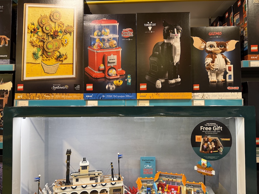 The LEGO Tuxedo Cat model on display, showcasing a realistic black-and-white cat sculpture with lifelike details and poseable features.