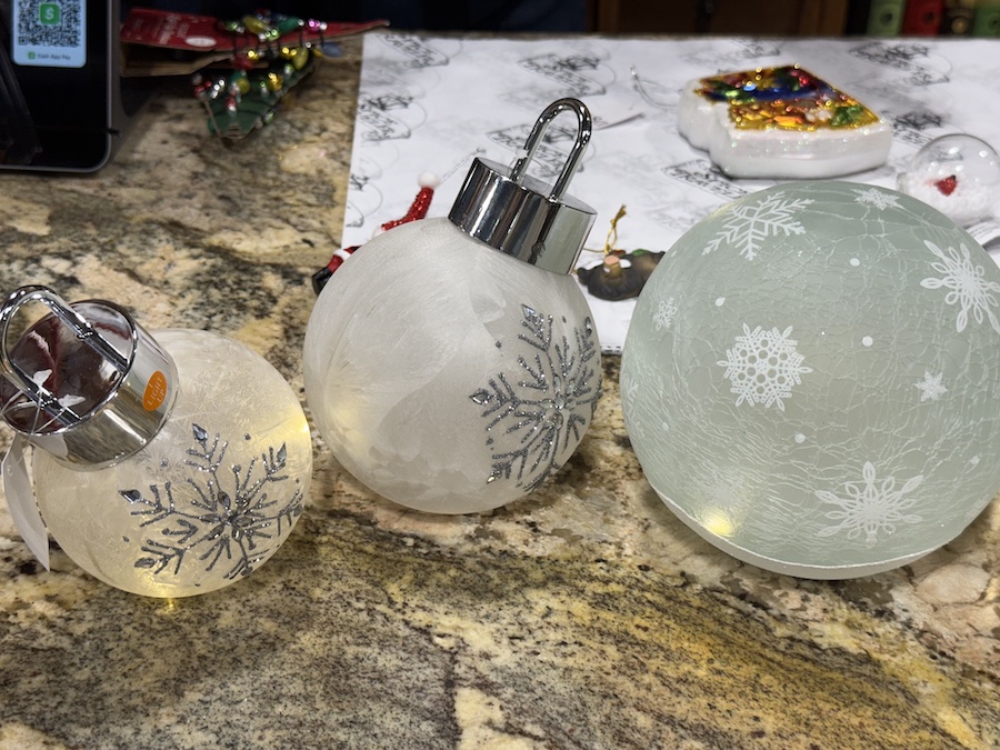 A close-up view of assorted Christmas tree balls displayed in-store at Spice Traveler in Prescott, Arizona.