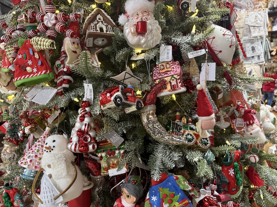 Christmas tree decorations displayed on themed holiday trees inside Spice Traveler