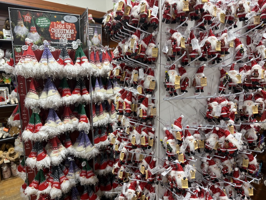 Light-up Christmas gnomes glowing softly on a shelf, adding whimsical charm to the holiday selection.