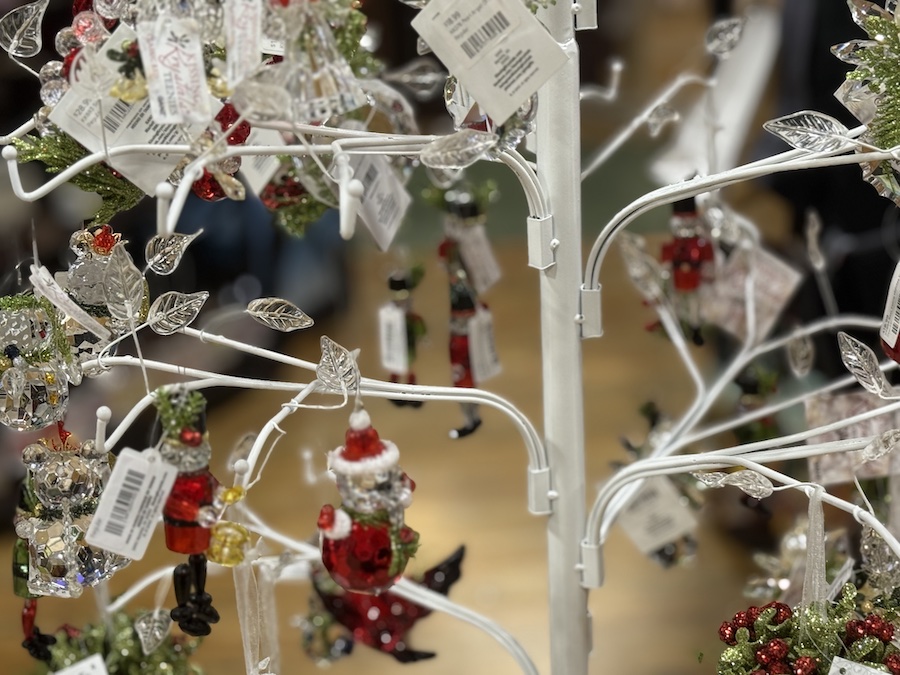 A close-up view of a sparkling Kissing Krystals Ganz ornaments hanging elegantly on a display rack.