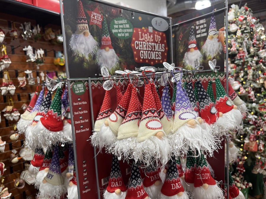 A set of charming light-up Christmas gnomes displayed on the shop shelf