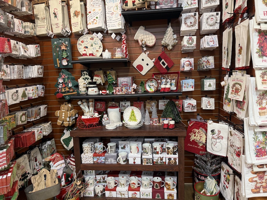 Holiday-themed napkins with cheerful Christmas prints stacked in a decorative display at Spice Traveler Prescott.