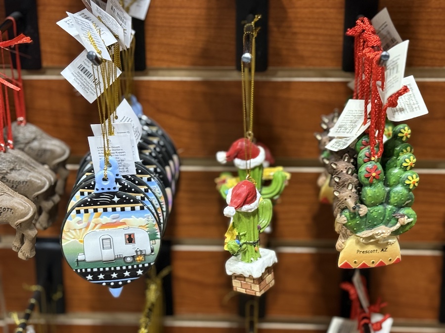 Prescott, Arizona, Christmas decorations with local symbols and inscriptions hung on a shelf.