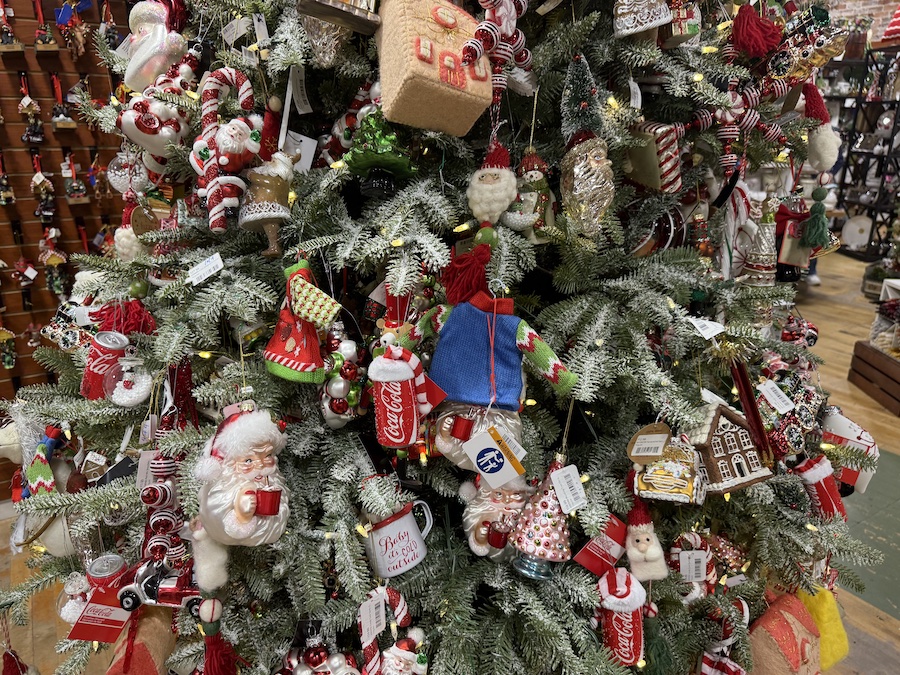 Explore beautiful Christmas tree decorations displayed on themed holiday trees inside Spice Traveler