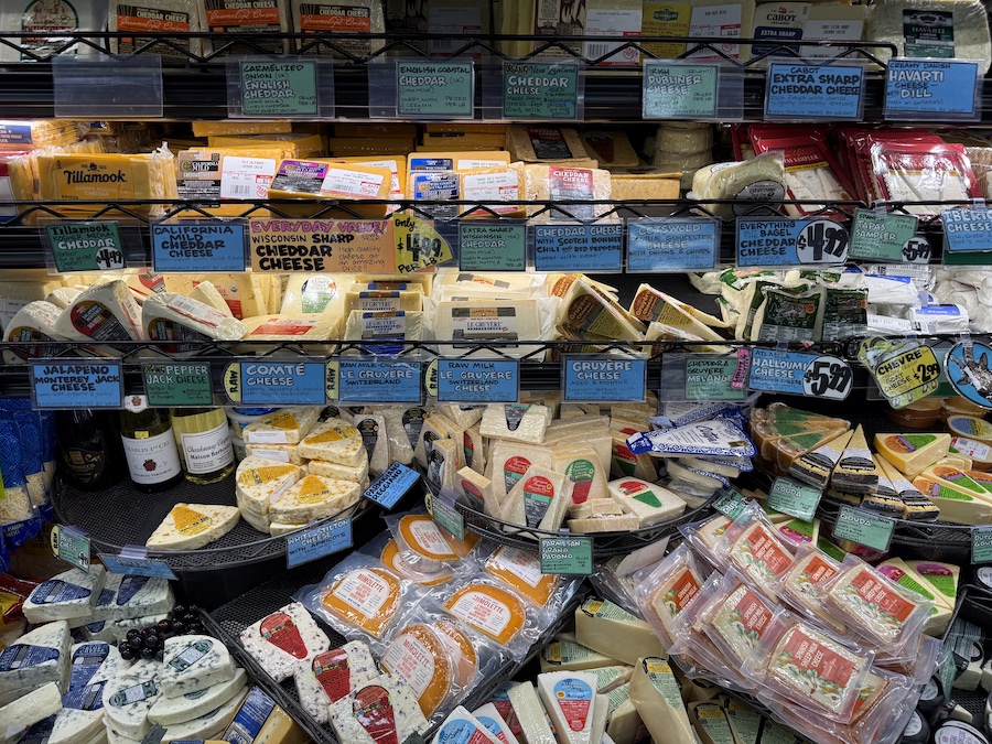 A wide range of cheeses arranged beautifully — creamy, sharp, and aromatic varieties side by side.