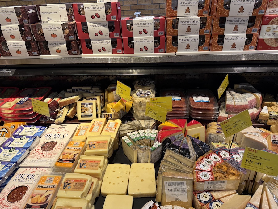 Large assortment of cheeses displayed at Whole Foods Market