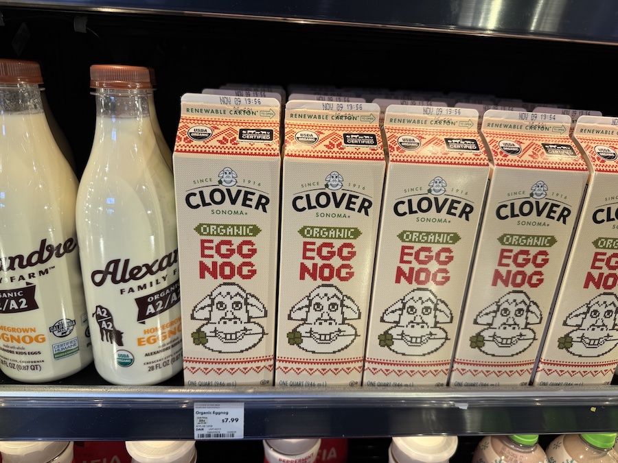 Bottles of Clover and Alexandre Family Farm eggnog neatly arranged in the refrigerated dairy section.