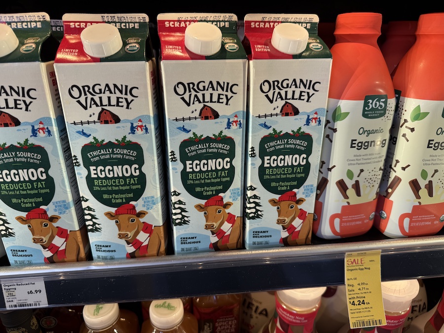 Organic Valley eggnog cartons in the cold case, highlighted with festive holiday-themed packaging.