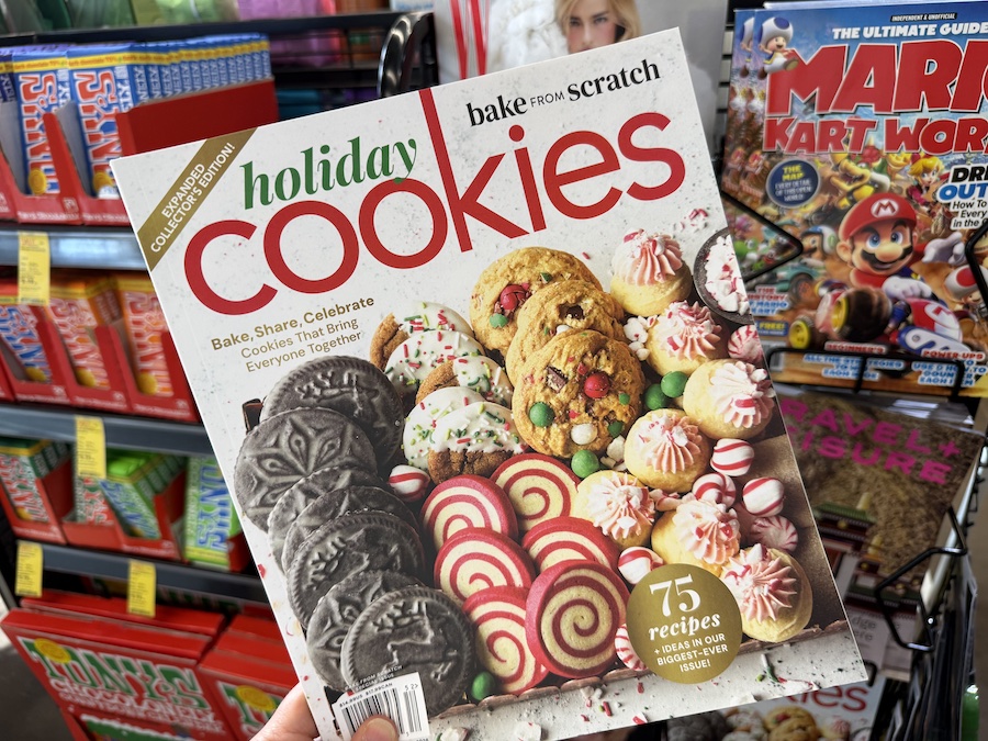 Holiday baking magazine featuring “75 Cookie Recipes” on a display rack near the checkout area.