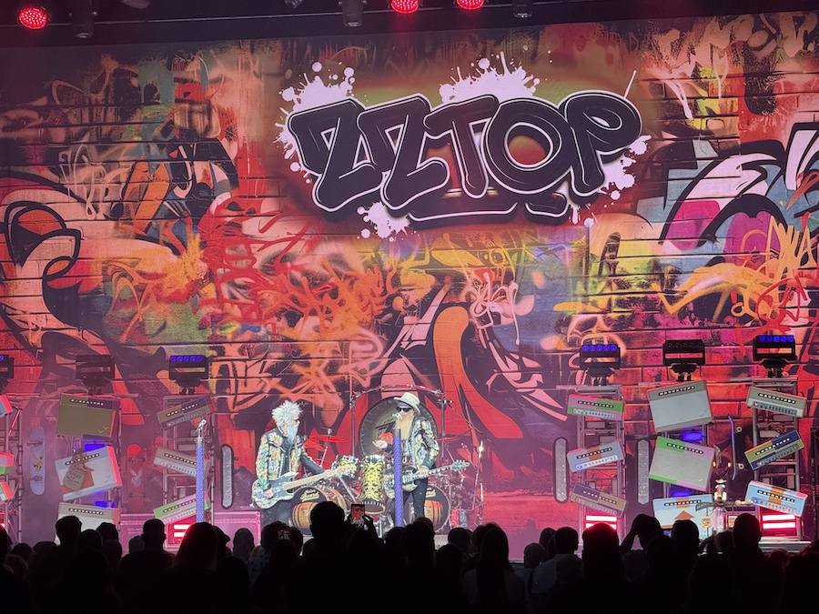 ZZ Top performing on stage under vibrant red and blue concert lights