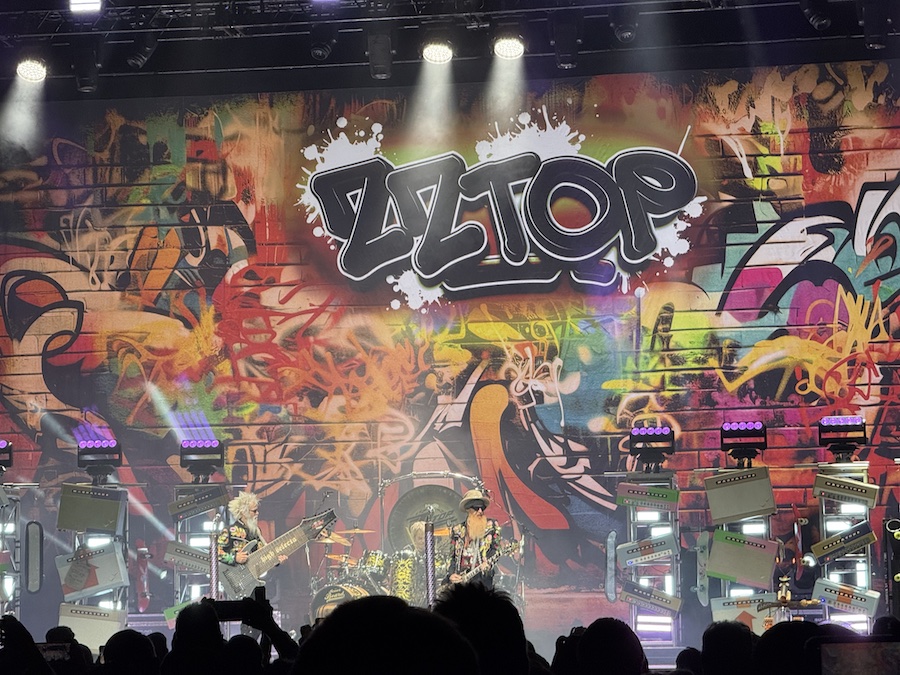 ZZ Top in the middle of a performance, playing their classic hits.